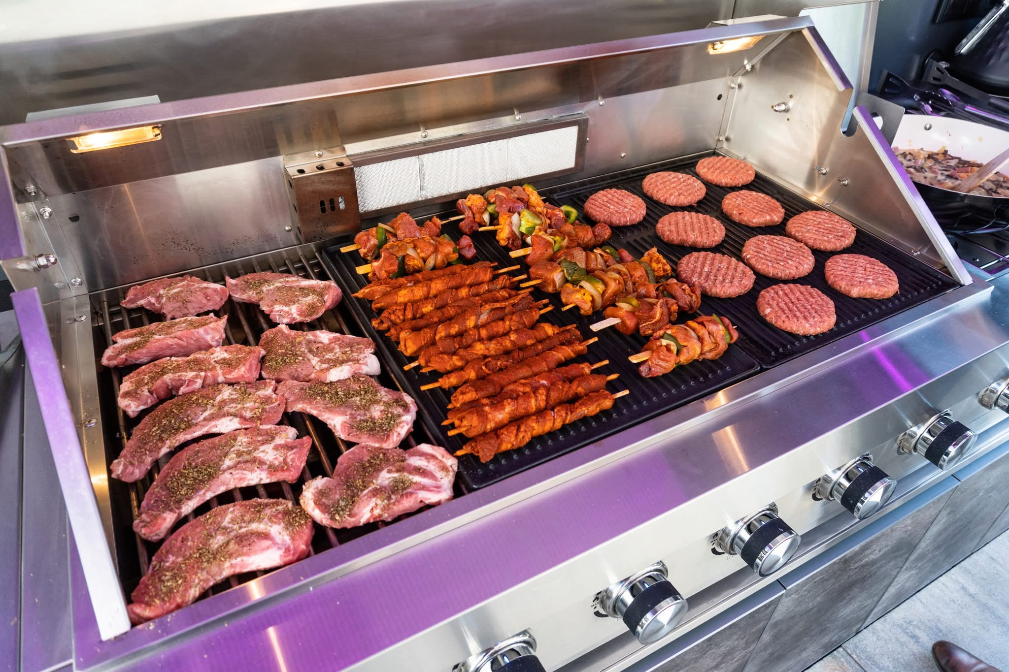 Close-up of stainless steel BBQ grill cooking food