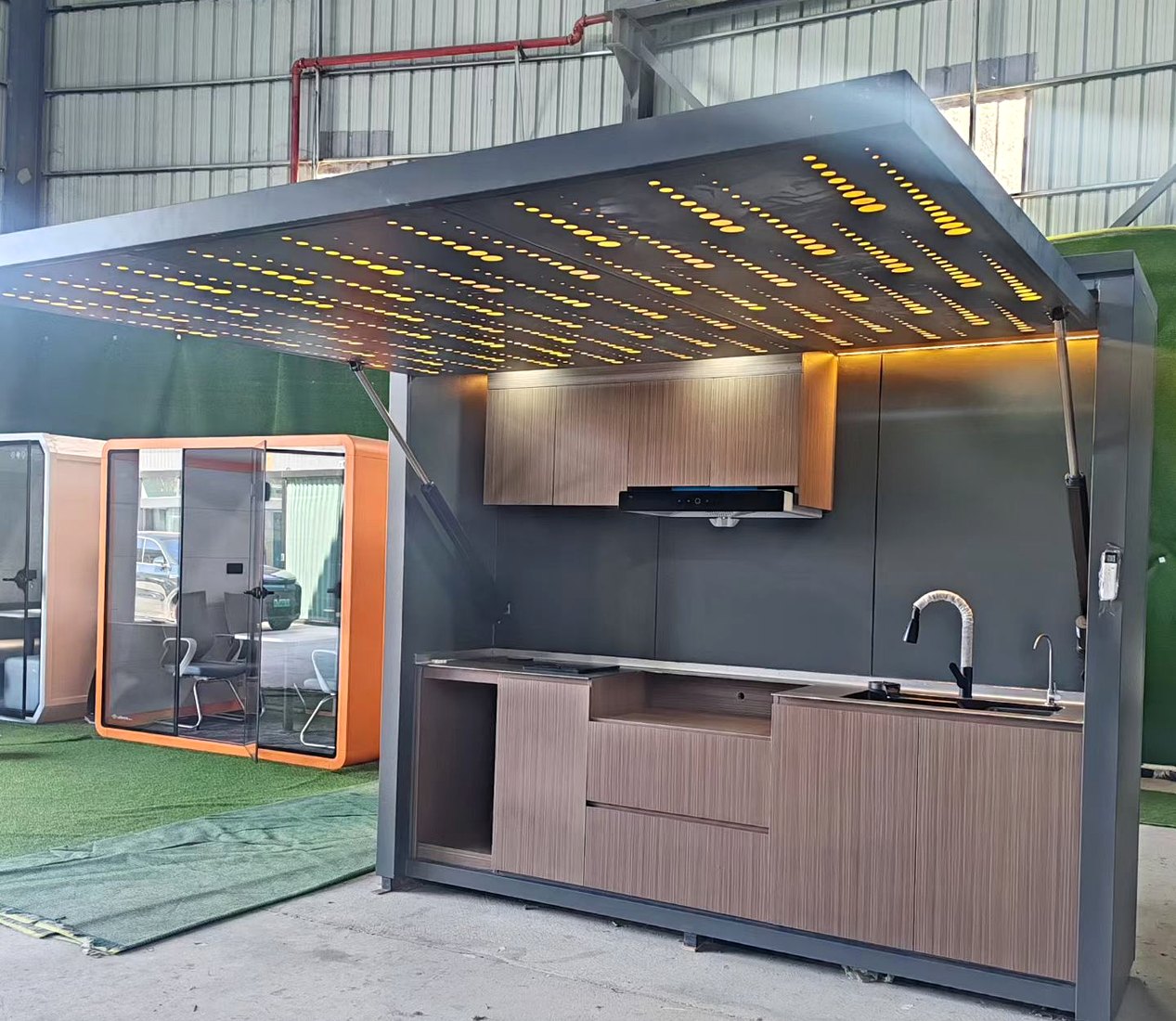 Outdoor kitchen with star ceiling installed in a landscaped setting